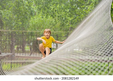 Practice Nets Playground. Boy Plays In The Playground Shielded With A Protective Safety Net. Concept Of Children On Line, Kid In Social Networks. Blurred Background, Blurred Motion Due To The Concept