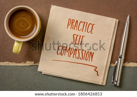 practice self-compassion inspirational handwriting on a napkin with coffee, mindset and personal development concept