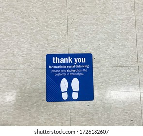 Practice Social Distancing Sign On The Ground At Grocery Store Supermarket During Outbreak Of Novel Coronavirus COVID-19 Pandemic In United States