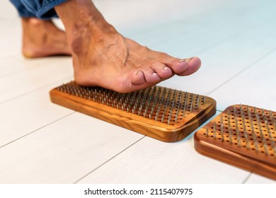 The practice of standing on nails. Close-up of a sadhu wooden board with nails for sadhu practice. Man stepping on nails