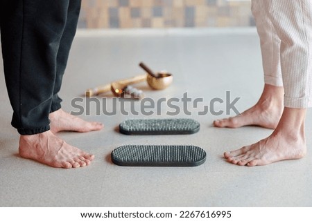 Practice of standing on nails. Close-up of legs before standing on sadhu board with sharp nails. Wooden sadhu board with nails for sadhu practice
