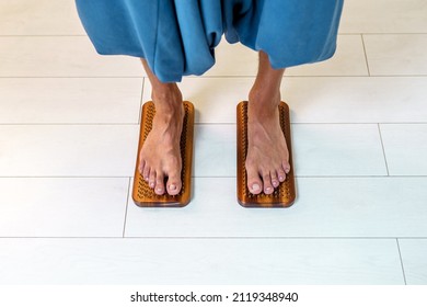 Practice of standing on nails. Sadhu wooden board with nails for sadhu practice. A man stands on nails on a light background