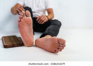 Practice of standing on nails. Sadhu wooden board with nails for sadhu practice. Close-up of a man foot with imprints from nails