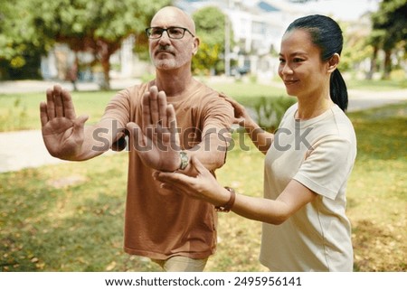 Practicing Tai Chi With Instructor in Public Park Setting