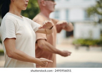 Practicing Tai Chi in Outdoor Urban Space with a Friend - Powered by Shutterstock