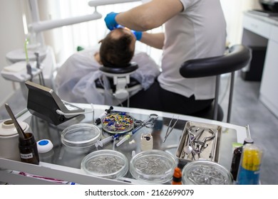 Practitioner Male Dentist Drilling Tooth To Patient In Dental Studio