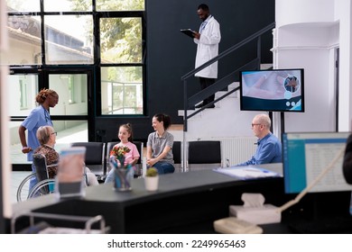 Practitioner nurse bringing elderly patient to family after finishing medical consultation, granddaughter holding bouquet flowers for grandmother. People standing in hospital reception. - Powered by Shutterstock