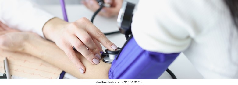 Practitioner Taking Blood Pressure Of Woman