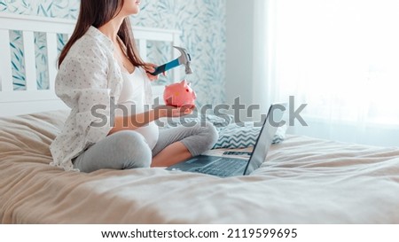 Pragnant woman with laptop on bed. Pregnant woman smashing a piggy bank with a hammer.