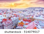 Prague in Christmas time, classical view on snowy roofs in central part of city.