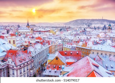 Prague in Christmas time, classical view on snowy roofs in central part of city.