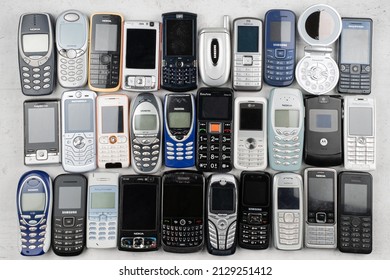 Prague, CZ - 12 December 2021: Phones with keyboards. A lot of old used mobile, Various brands. Many types and generations of mobile smartphone gadgets are in the heap. Editorial
