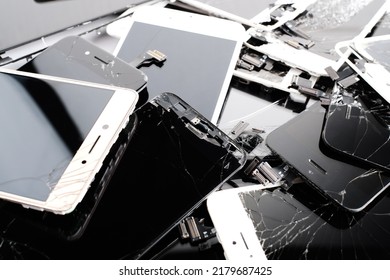 Prague, CZ - 16 January 2022:  Heap, A Lot Of Used Broken  IPhone Screens On White Bg. Crashed Screen Glass Lcd.  Gadget Parts Lying One On Top Of Another. For Utilization Recycle Concept. Editorial