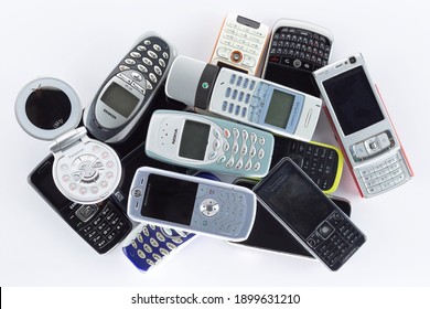 Prague, CZ- 21 January 2021:  Heap of Various brand old mobile phones. various types and generations gadgets. Editorial