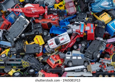 Prague, CZ 25 April 2021: Cars Heap Pile Of Vintage Retro Toys Used, Broken Or Damaged Assorted Colors Cabs.   A Lot Of Toy Car For Reuse On Market, Above Top View. Childhood Concept. EDITORIAL