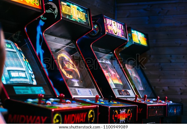 Prague, CZ - August 2017: Most Iconic Vintage Arcade\
Games Including fighting game Mortal Combat stored in a dark gamer\
room