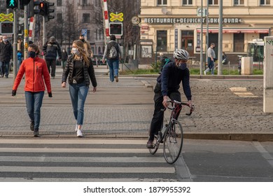 Prague, Czech Republic. 03-08-2020. Biker And Pedestrian Cross The Tram Rails In City. In Prague, Despite Quarantine People Go Outside To Have A Good Time, To Do Exercise, To Walk, To Run, To Bike.