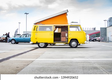 Prague / Czech Republic - April 3th 2019: Side view of old yellow Volkswagen California campervan parked on a roof of a shopping mall during Classic Drive event.
