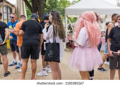 Prague, Czech Republic - August 7, 2021. People in line with rainbow flags and costumes at the Pride Village on Strelecky Island at annual Prague Pride festival