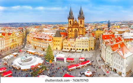 Prague, Czech Republic, Bohemia. Christmas Market in Stare Mesto old square. View on snow classic red roofs, Christmas fair, Christmas tree in center of square, Tyn Church. Iconic landmark in Europe. - Powered by Shutterstock