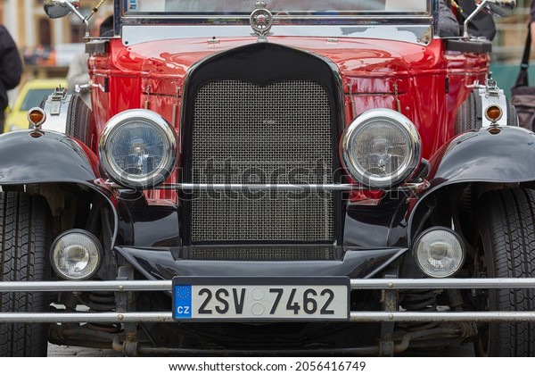 Prague, Czech\
Republic - Circa 2018: Red retro car font in the touristic old\
town. It\'s service tourists can rent for sightseeing landmarks in\
the historic old town city\
center