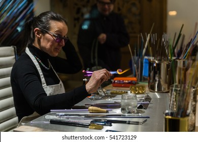 PRAGUE, CZECH REPUBLIC - DECEMBER, 2016: Woman - master of stone carving working in a workshop.