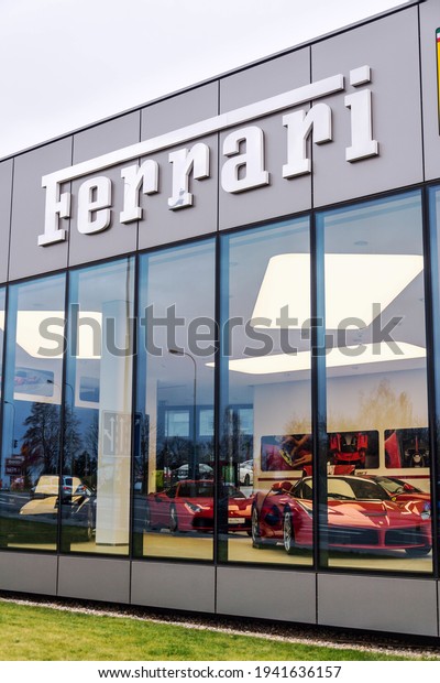 PRAGUE, CZECH REPUBLIC - DECEMBER 23 2018: Ferrari N. V.\
Italian luxury sports car manufacturer company logo in front of\
dealership building on December 23, 2018 in Prague, Czech Republic.\

