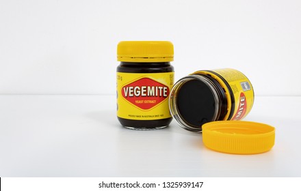 Prague, CZECH REPUBLIC - February 28, 2019: A studio shot of a 220g jars of Vegemite on white desk in front of white wall. Vegemite is a very popular yeast based spread in Australia
