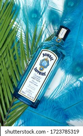 Prague, Czech Republic- February 9, 2020. Bombay Sapphire Gin in blue glass bottle and palm leaf