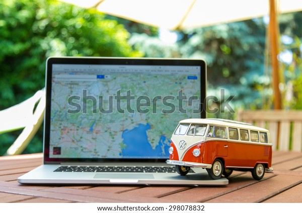 PRAGUE, CZECH REPUBLIC\
- JULY 10, 2015: Miniature VW Bulli 1962 on laptop. The cult car of\
the Hippie generation and it remained the status vehicle of the\
high wave surfers.