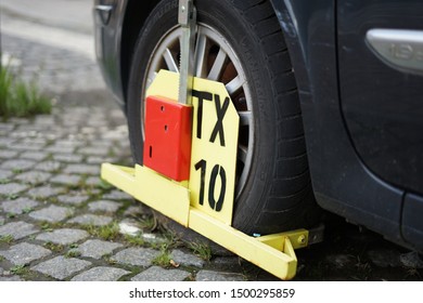 Prague, Czech Republic - July 13 2019: Yellow Wheel Clamp, Also Known As Wheel Boot, Parking Boot, Or Denver Boot