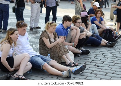 Prague, Czech Republic - June 30: Group Of The People Sit On The Sidewalk On June 30, 2015 In Prague, Czech Republic.