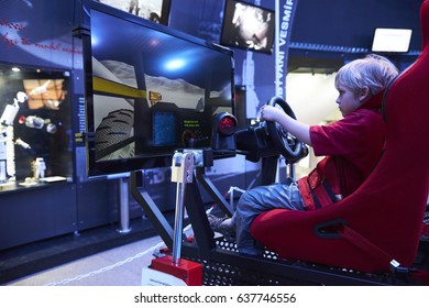 Prague, Czech Republic - May 12, 2013: Child Boy Driving High Sophisticated Simulator Of Rover. Simulator Simulates Ride Along The Surface Of The Mars Planet In Planetarium Prague