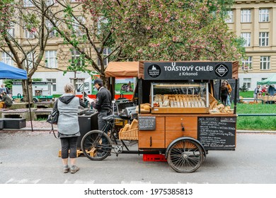 Prague, Czech Republic - May 15, 2021.Traditional Farmers Market In Quarter Of Dejvice. Seller And Customer In Surgical Masks Against Covid19 Coronavirus.Street Retro Vendor With Pastry And Bread