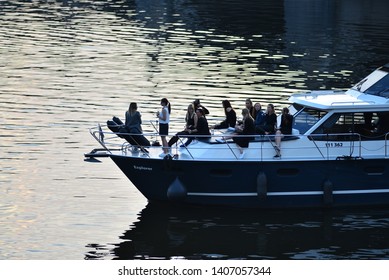 Prague, Czech Republic - May 24 2019: Silhouettes Of Young Women Having A Bachelorette Party On A Front Part Of A Big Luxury Boat In The Middle Of The Vltava River. Evening. Still Water.