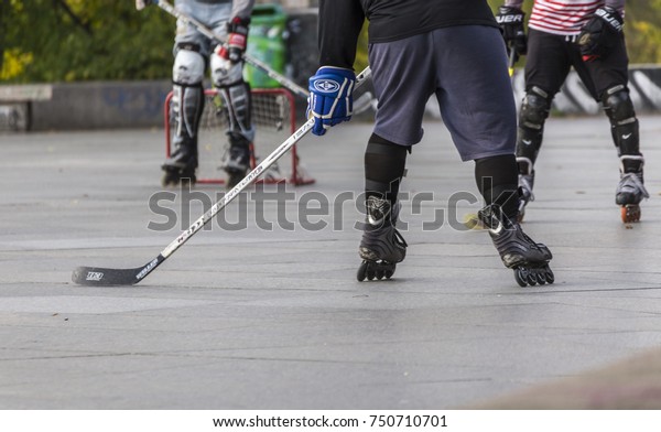 PRAGUE, CZECH REPUBLIC - OCTOBER 12, 2017 - Low\
angle view of people playing street hockey in Letna Park in Prague,\
Czech Republic.