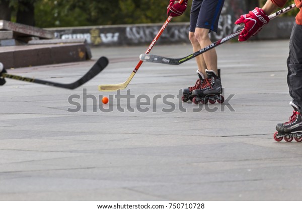 PRAGUE, CZECH REPUBLIC - OCTOBER 12, 2017 - Low\
angle view of people playing street hockey in Letna Park in Prague,\
Czech Republic.
