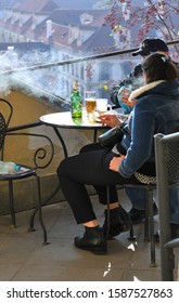 PRAGUE, CZECH REPUBLIC - October 31, 2019: Prague cityscape with a table of a small cafe on the observation deck. Beer, cigarettes, nice company. - Shutterstock ID 1587527863