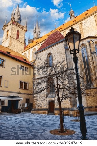 Prague, Czech Republic. Old Town square with Tyn Church of Our Lady before in prague ove blue sky clouds. Ancient Praha street perspective. Famous touristic attraction Europe.