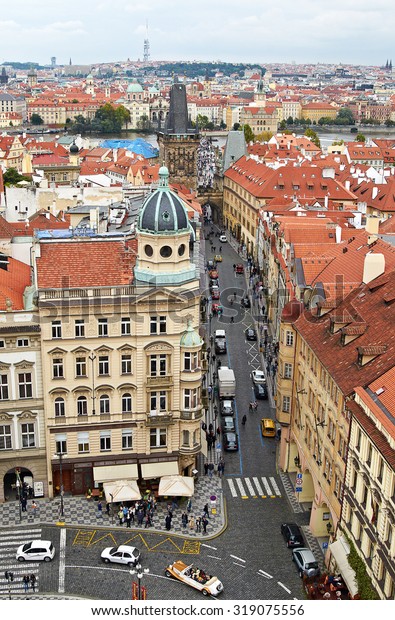 Prague, Czech\
Republic, September 25, 2014. Top view of the city from the Town\
belfry by St. Nichola\'s Church. Mala Strana square with red roofs\
and cathedral, cars on the\
road