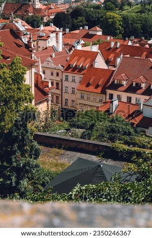 Prague, Czechia: Aerial city view with colorful roofs, architecture, and greenery.