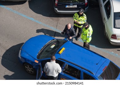 PRAGUE, CZECHIA - Mar 27, 2014: Police Observe As Driver Of Illegally Double-parked Ford Mondeo Station Wagon, Blocking Traffic On Stepanska Street, Has A Discussion With Taxicab Driver.  Local News.