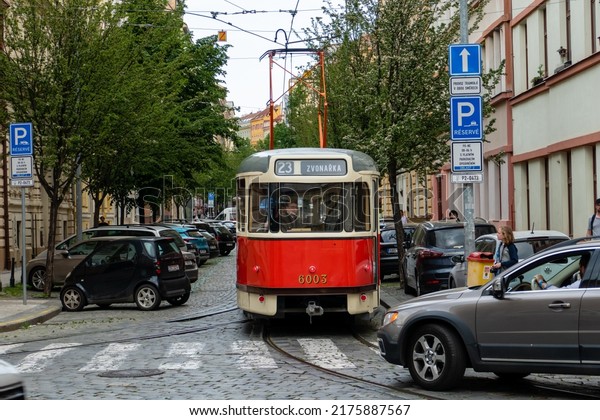 PRAGUE, CZECHIA - May 16, 2022: First day of operation\
nostalgic tram line 23 after close up because of covid-19. Tatra T2\
tram car reversing at the triangle turnstile. Cars often block\
trams.  