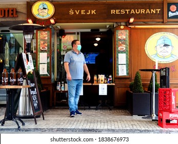 PRAGUE, CZECHIA - Opened And Empty Restaurant Svejk With Waiter Wearing Face Mask Despite All The Difficulties Due To The Country Lockdown Caused By Covid-19 Pandemics, Czech Republic,  10/20/2020