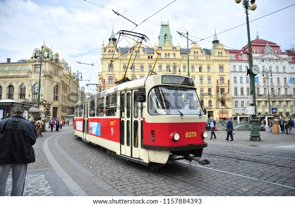 Prague/Czech Republic-\
09/18/2017: A tram pulls into a stop as people wait in Prague\'s\
historic center.