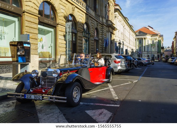 PRAGUE/CZECH\
REPUBLIC-OCTOBER,26,2019:Old Car Hire in Old Town (Stare Mesto) in\
front of Preciosa\
Store