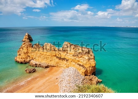 Praia da Dona Ana beach, Lagos, Algarve region, Portugal. Praia Dona Ana surrounded by steep colourful strata cliffs. One of the most picturesque beaches in Algarve. 