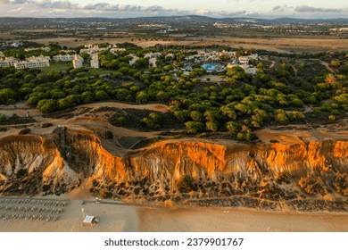 Praia da Falesia, Algarve beach in Albufeira, Portugal. Aerial drone view at sunset
