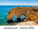 Praia da Marinha, beautiful beach Marinha in Algarve, Portugal. Navy Beach (Praia da Marinha) with flying seagulls over the beach, located on the Atlantic coast in Lagoa Municipality, Algarve.