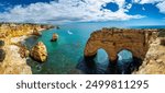 Praia da Marinha, beautiful beach Marinha in Algarve, Portugal. Navy Beach (Praia da Marinha) with flying seagulls over the beach, located on the Atlantic coast in Lagoa Municipality, Algarve.